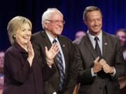 Democratic presidential candidates Hillary Rodham Clinton, from left, Sen. Bernie Sanders, I-Vt., and former Maryland Gov. Martin O'Malley, smile after a Democratic presidential candidate forum Nov. 6 at Winthrop University in Rock Hill, S.C. Clinton has locked up public support from half of the Democratic insiders who cast ballots at the party's national convention, giving her a commanding advantage over her rivals for the party's presidential nomination. Clinton's margin over Sanders and OMalley is striking.