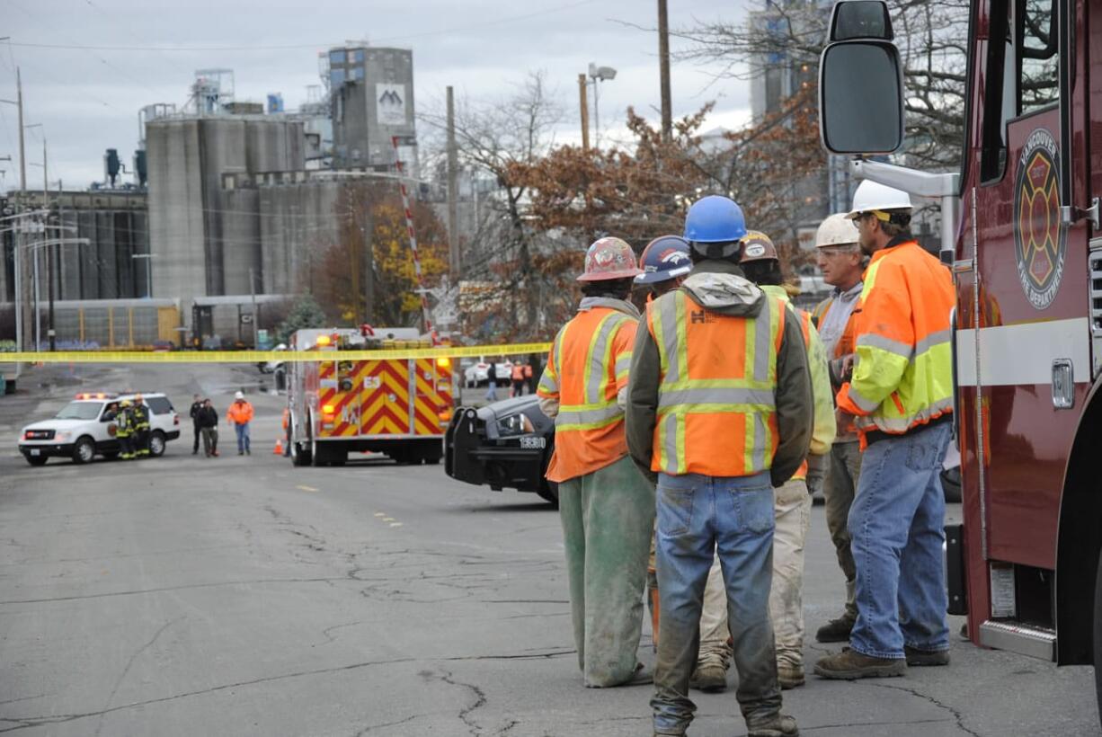 Workers wait outside Vancouver Warehouse and Distribution Co., 1101 W.