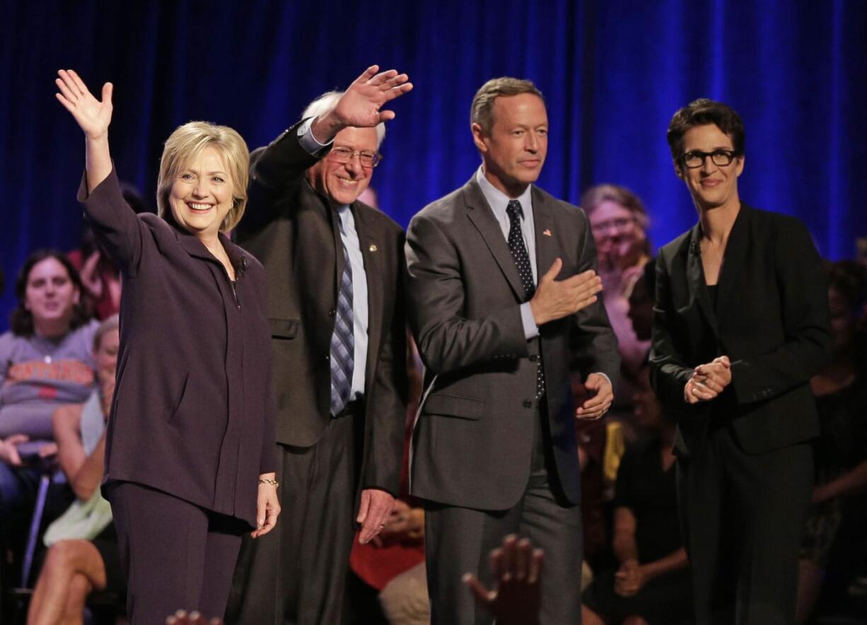 Democratic presidential candidates Hillary Rodham Clinton, left, Sen. Bernie Sanders, I-Vt, second from left, former Maryland Gov. Martin O'Malley, second from right, and MSNBC's Rachel Maddow, right, acknowledge the crowd after a democratic presidential candidate forum at Winthrop University in Rock Hill, S.C., Friday, Nov. 6, 2015.