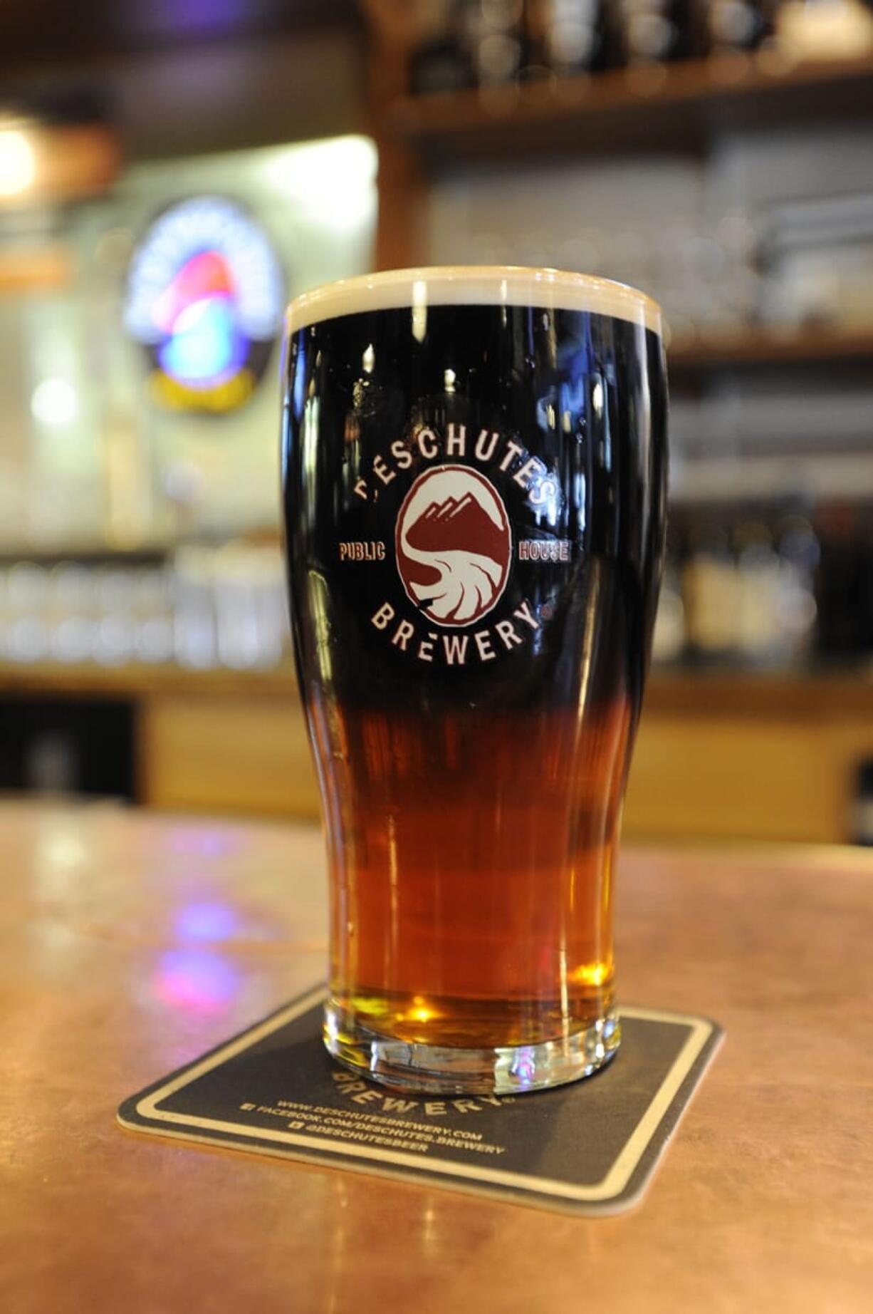 A black and tan -- Obsidian Stout on top and Red Chair beer on the bottom -- sits on the bar at Deschutes Brewery Pub  in Bend, Ore.