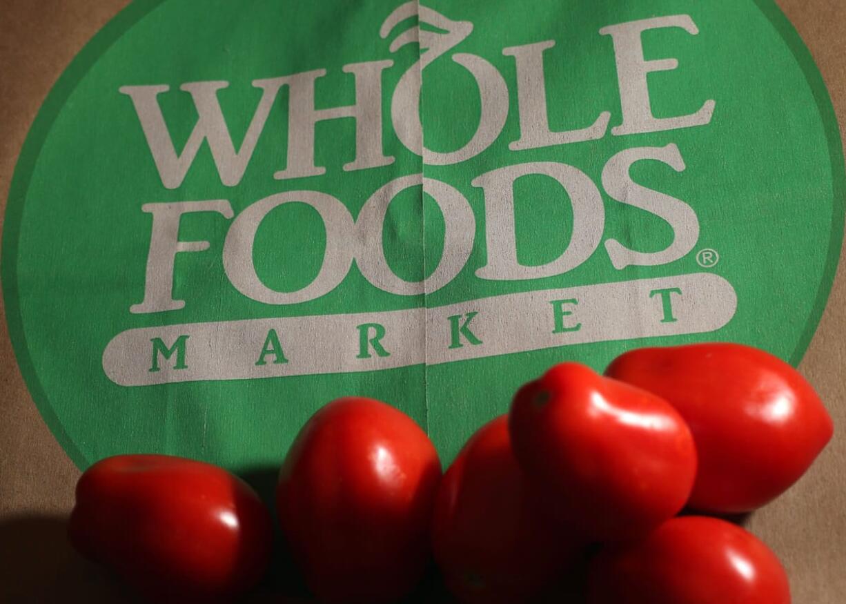 Whole Foods Market Inc., the largest natural foods grocer in the United States, fell the most in four years after saying that fiscal 2014 profit would be less than it previously forecast as same-store sales growth slows.