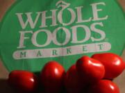 Whole Foods Market Inc., the largest natural foods grocer in the United States, fell the most in four years after saying that fiscal 2014 profit would be less than it previously forecast as same-store sales growth slows.