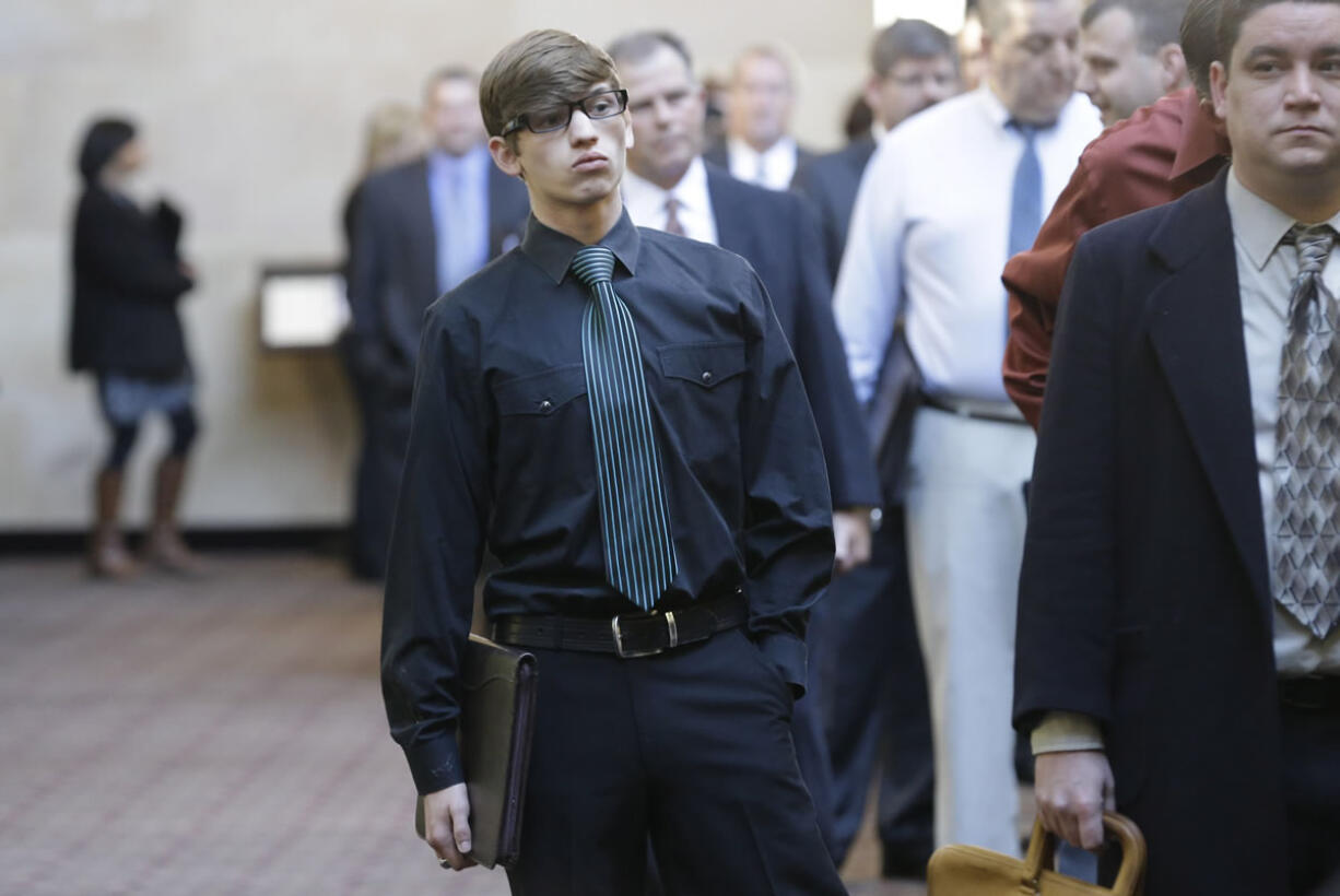 Austin Moore, 18, lines up with other job seekers during a career fair at a hotel in Dallas.