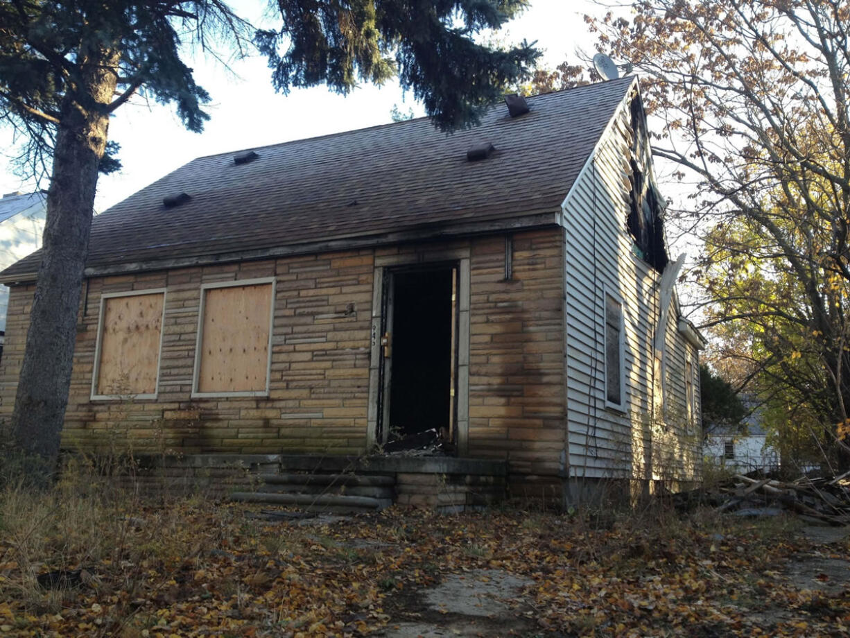 Fire crews responded Thursday evening to the boarded-up bungalow that was the childhood home of rapper Eminem in Detroit. The house is pictured on the cover of Eminem's just-released &quot;The Marshall Mathers LP 2.&quot; It also was on the musician's 2000 album &quot;The Marshall Mathers LP.&quot; The blaze damaged portions of the small home's top floor.