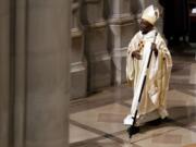 Episcopal Church Presiding Bishop Michael Curry walks with the pastoral staff during Mass at the Washington National Cathedral on Sunday in Washington.