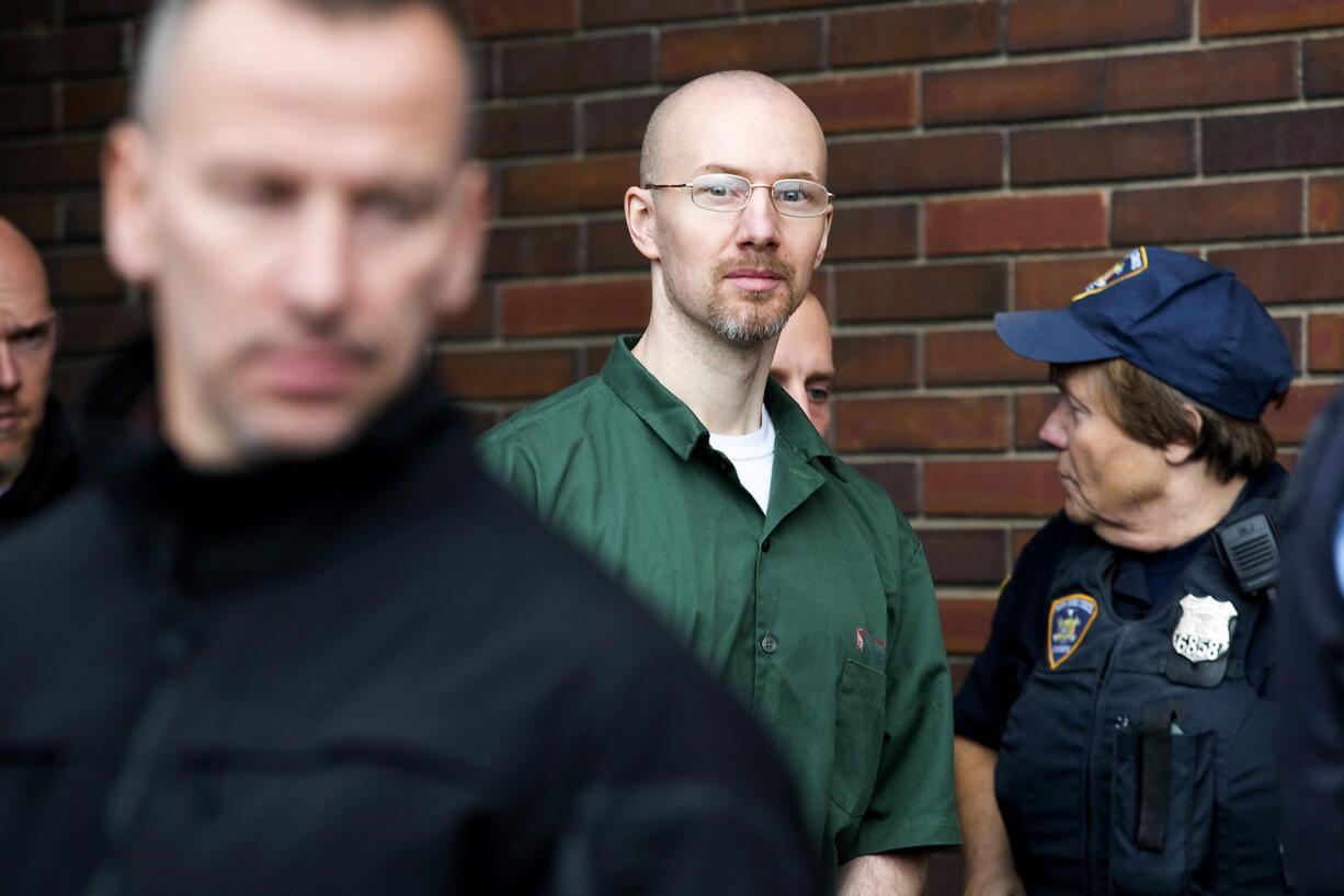 David Sweat is led out of the Clinton County Government Center under heavy guard Friday following his court appearance in which he pleaded guilty to one count of promoting prison contraband and two counts of escape in the first degree in Plattsburgh, N.Y.