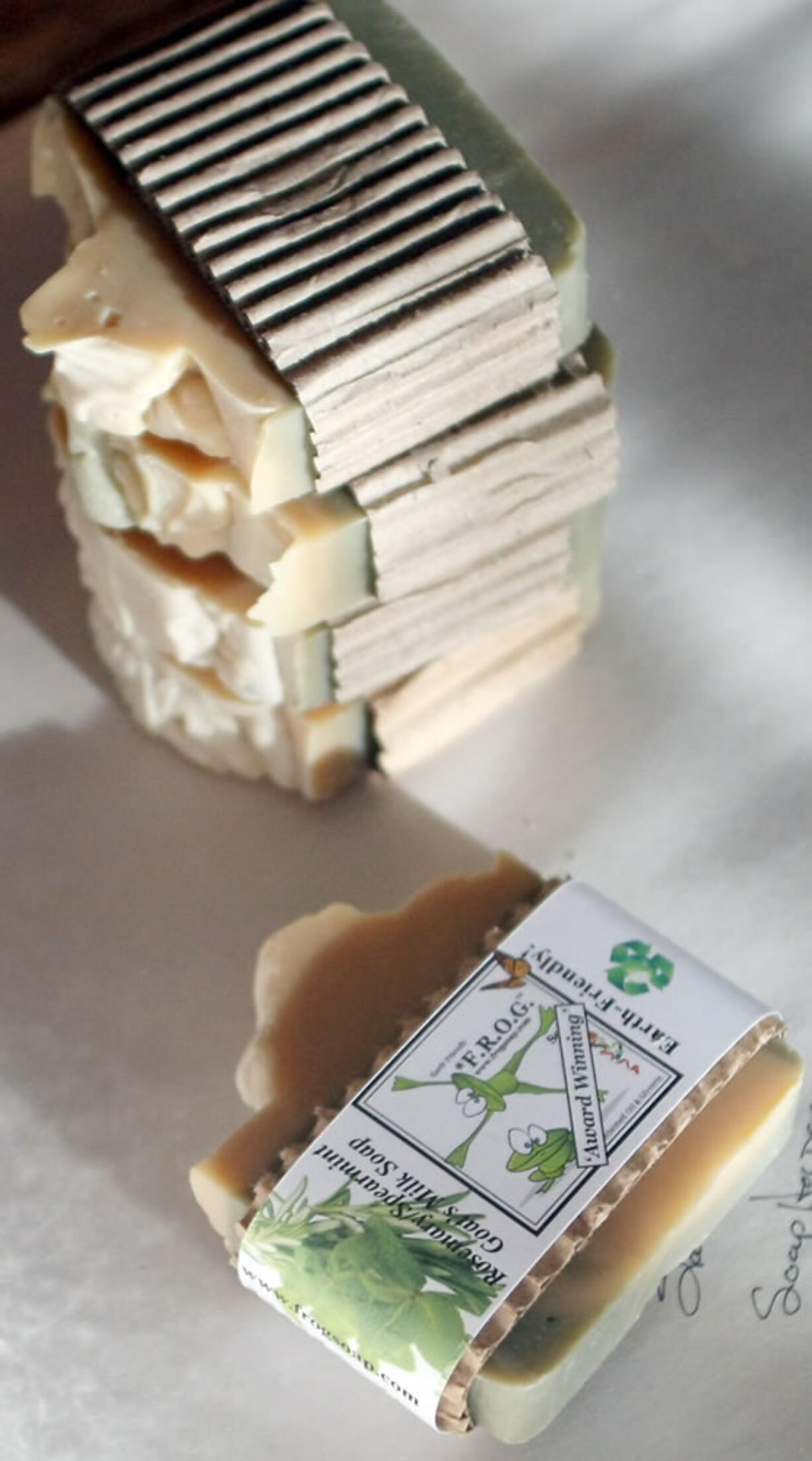 Bars of Rosemary Spearmint Goats Milk F.R.O.G. soap await final packaging at Laura Kneib's home in Bremerton, Wash. on Dec. 3, 2013.  Kneib carefully filters the oil and mixes it with lye, water, essential oils and other natural ingredients to create a variety of cleansers. She calls it FROG Soap, an acronym for &quot;From Recycled Oil &amp; Glycerin.&quot; (AP Photo / KItsap Sun, Meegan M.