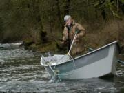 Ed Wickersham of Ridgefield nets a hatchery winter steelhead downstream of Lewisville Park on the East Fork of the Lewis River.