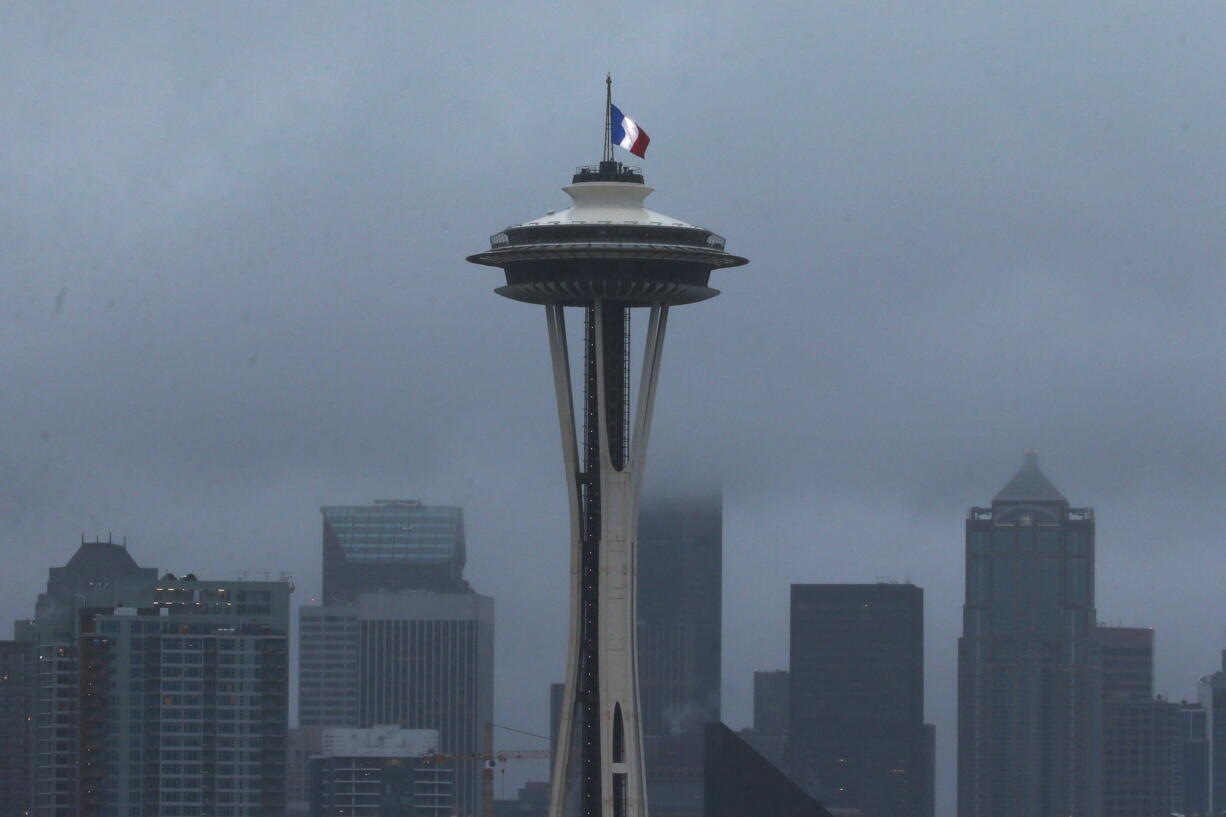 The French flag flies at half-staff atop of the Space Needle in Seattle on Saturday, Nov. 14, 2015. Multiple attacks across Paris on Friday night killed scores and injured hundreds.