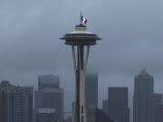The French flag flies at half-staff atop of the Space Needle in Seattle on Saturday, Nov. 14, 2015. Multiple attacks across Paris on Friday night killed scores and injured hundreds.