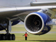 A ground controller stands next to the Rolls Royce engine of a British Airways Airbus A380 during the first day of the 50th Paris Air Show at Le Bourget airport in June.