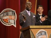 Inductee Gary Payton, left, speaks during the enshrinement ceremony for the 2013 class of the Naismith Memorial Basketball Hall of Fame as Hall of Famer John Stockton, right, looks on at Symphony Hall in Springfield, Mass., Sunday, Sept. 8, 2013.