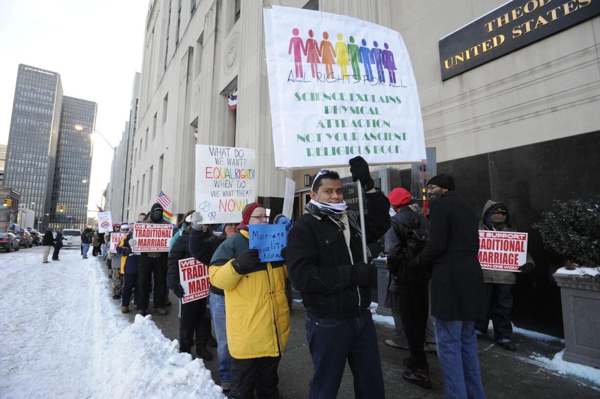 Protestors demonstrate outside Federal Courthouse before a trial that could overturn Michigan's ban on gay marriage in Detroit on Monday in Detroit.