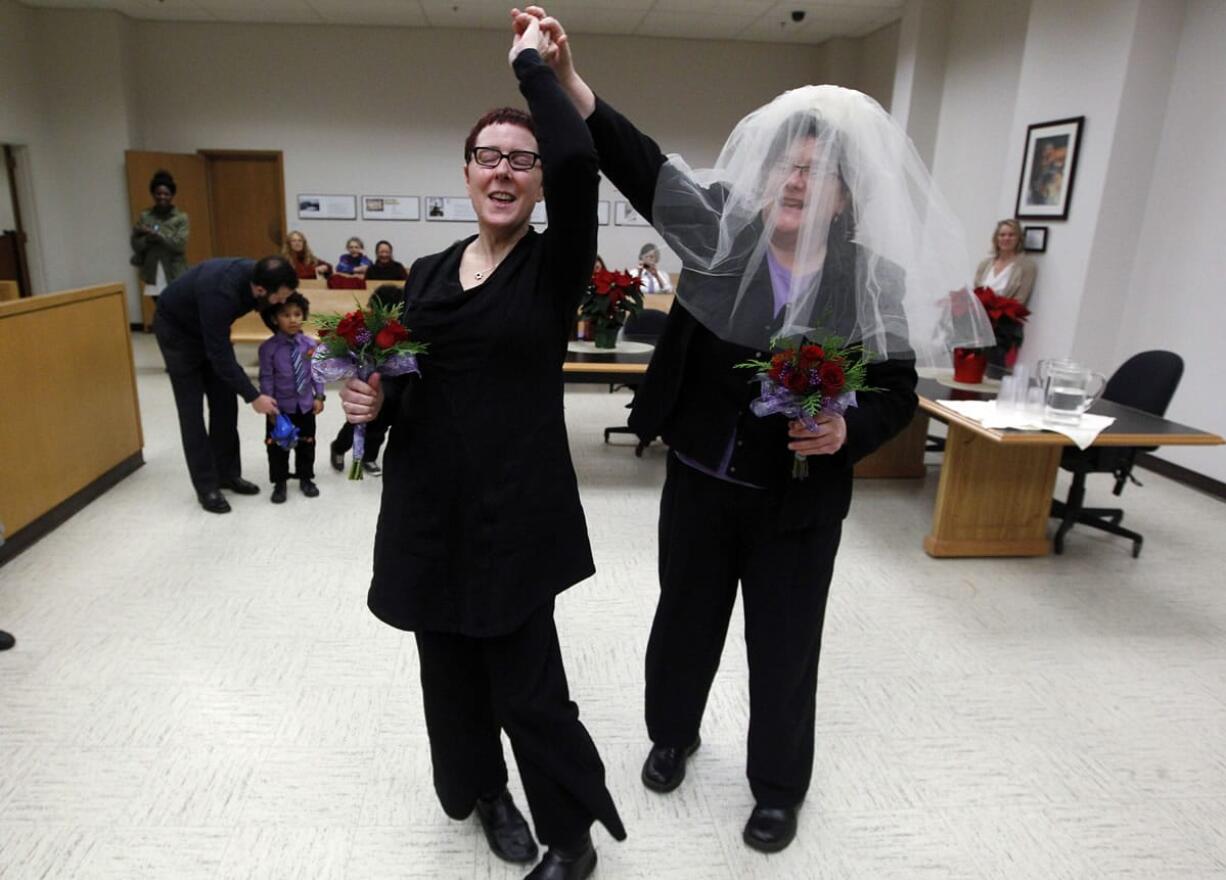 Cynthia Wallace, left, and soon-to-be-wife Julie Fein spin a few dance steps as they prepare to take their wedding vows in the early morning hours of Dec. 9, 2012, in the courtroom of Judge Mary Yu in the King County Courthouse, becoming among the first gay couples in the state to legally wed, in Seattle.