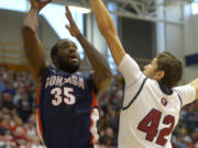 Gonzaga center Sam Dower, left, shoots as Loyola Marymount forward Marin Mornar defends during the first half Saturday at Los Angeles. (AP Photo/Mark J.