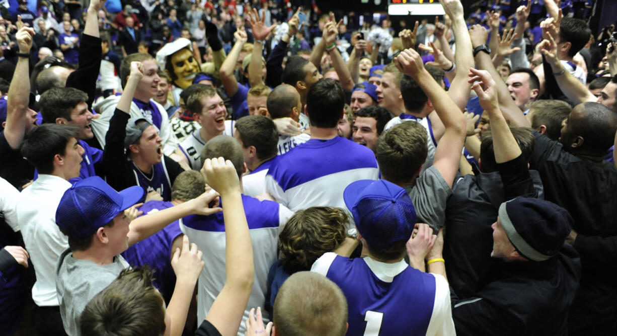 Players and fans celebrate at mid court after the Portland Pilots beat the Gonzaga Bulldogs 82-73 in a West Coast Conference game at the Chiles Center on Thursday.