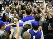 Players and fans celebrate at mid court after the Portland Pilots beat the Gonzaga Bulldogs 82-73 in a West Coast Conference game at the Chiles Center on Thursday.