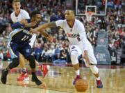 Portland Trail Blazers guard Damian Lillard, right, dribbles past Memphis Grizzlies guard Mike Conley during the first half of an NBA basketball game in Portland, Ore., Thursday, Nov. 5, 2015.