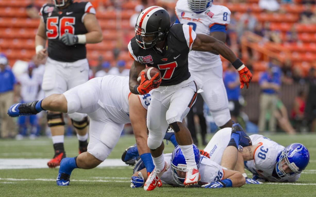 Oregon State wide receiver Brandin Cooks breaks away from Boise State defenders in the first quarter of the Hawai'i Bowl on Tuesday.