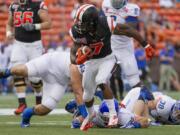 Oregon State wide receiver Brandin Cooks breaks away from Boise State defenders in the first quarter of the Hawai'i Bowl on Tuesday.