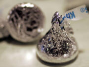 Hershey&#039;s Chocolate Kiss sits on the belt at Hershey&#039;s Chocolate World in Hershey, Pa. The candy company says its milk chocolate Hershey&#039;s Kisses and bars are now being made with flavor from real vanilla instead of an artificial flavor. The change is the first part of The Hershey Co.&#039;s previously announced plans to use simpler ingredients.