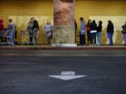 Shoppers wait outside a Kmart store for it to open Thursday in Anaheim, Calif.