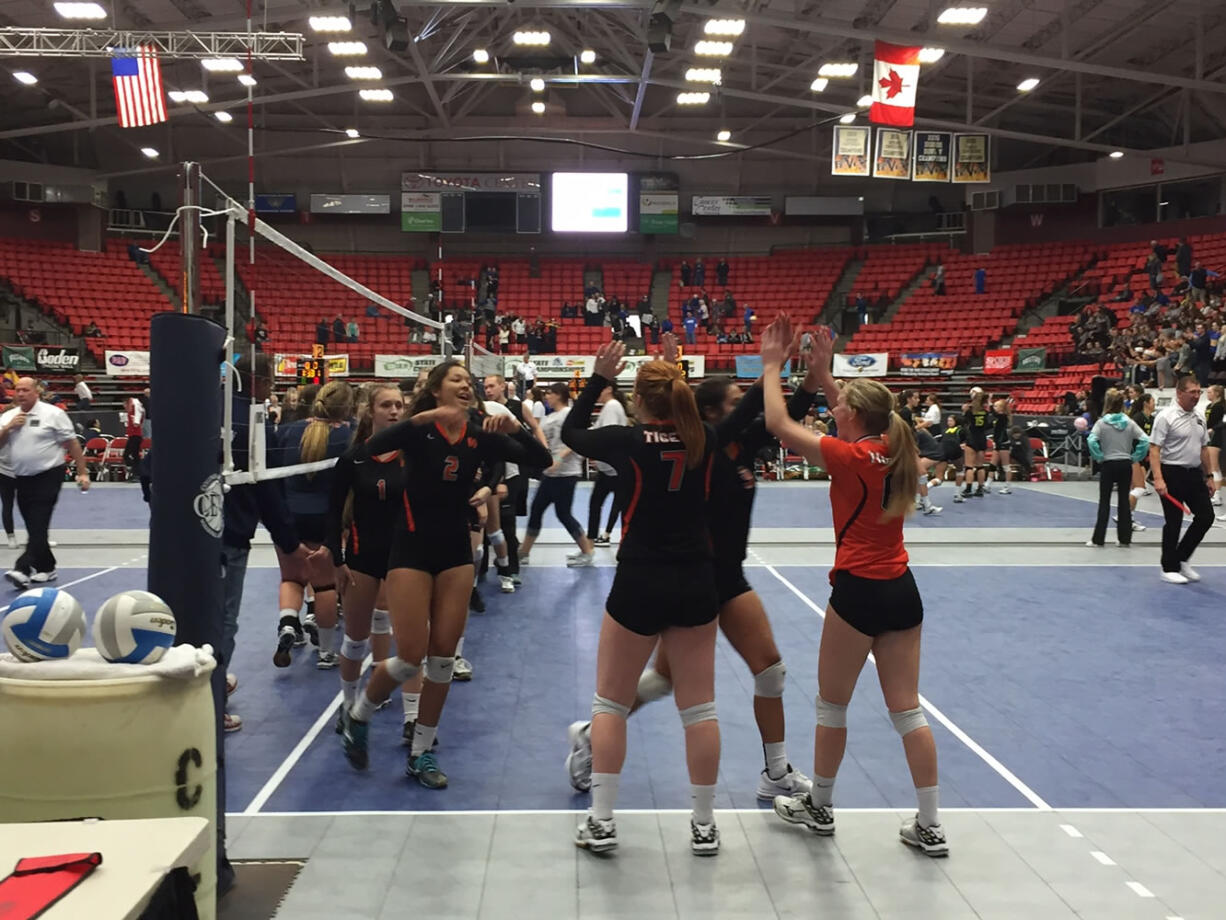 Battle Ground's volleyball team celebrates a first-round win over Eisenhower at the 4A state tournament on Friday in Kennewick (Micah Rice/The Columbian).