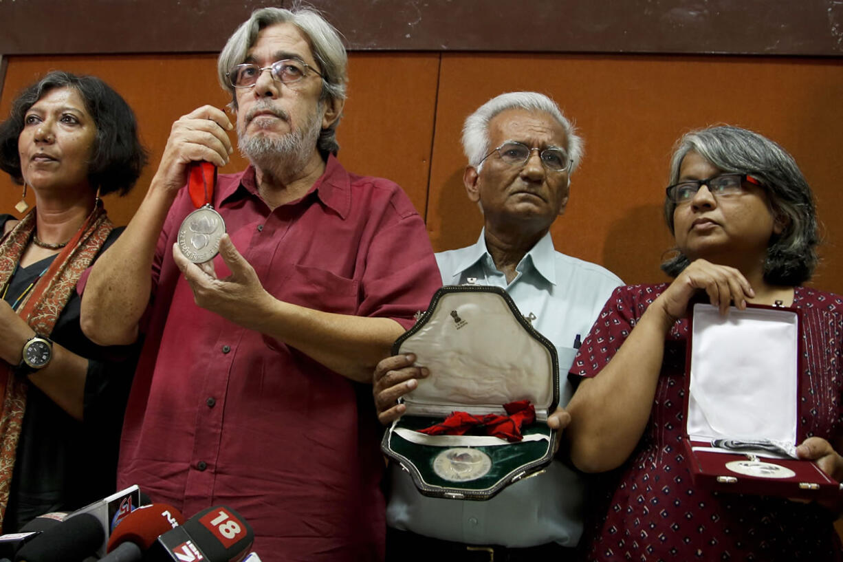 From left, Madhushree Dutta, Saeed Mirza, Kundan Shah and Irene Malik Dhar who are among Indian film industry figures returning National Film Awards pose before the media in Mumbai, India, on Thursday.