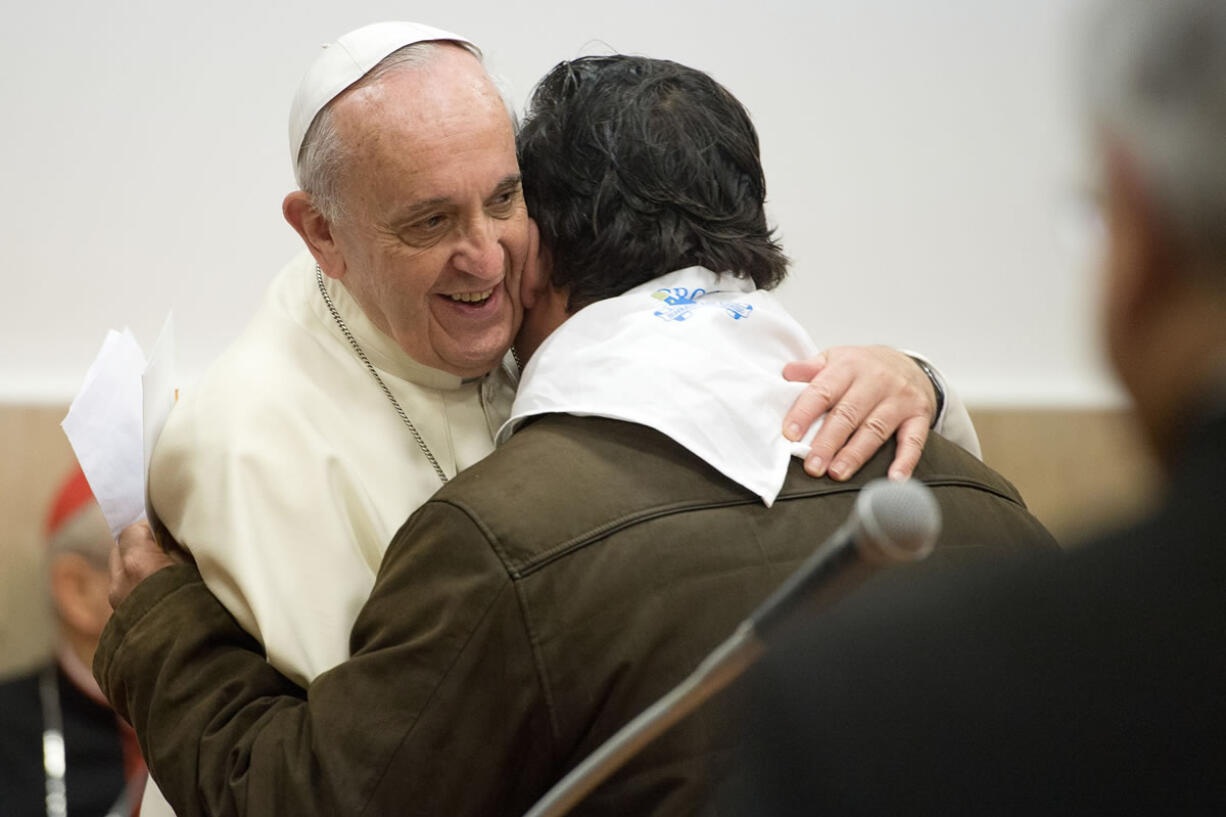 Pope Francis hugs a faithful on the occasion of his visit to the Sacro Cuore church in Rome on Sunday.