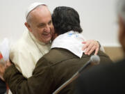 Pope Francis hugs a faithful on the occasion of his visit to the Sacro Cuore church in Rome on Sunday.