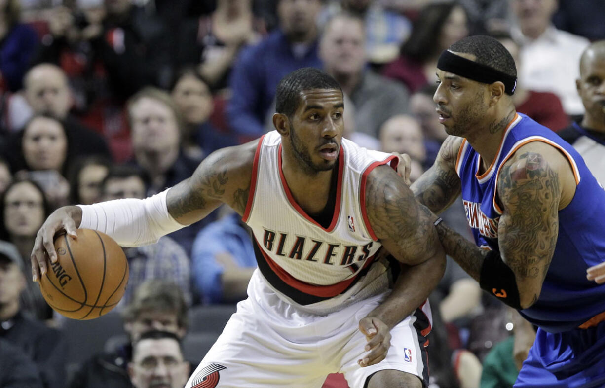 Portland Trail Blazers forward LaMarcus Aldridge, left, backs in on New York Knicks forward Kenyon Martin during the first half of an NBA basketball game in Portland, Ore., Monday, Nov.