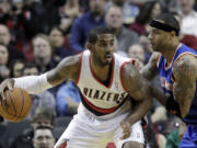 Portland Trail Blazers forward LaMarcus Aldridge, left, backs in on New York Knicks forward Kenyon Martin during the first half of an NBA basketball game in Portland, Ore., Monday, Nov.