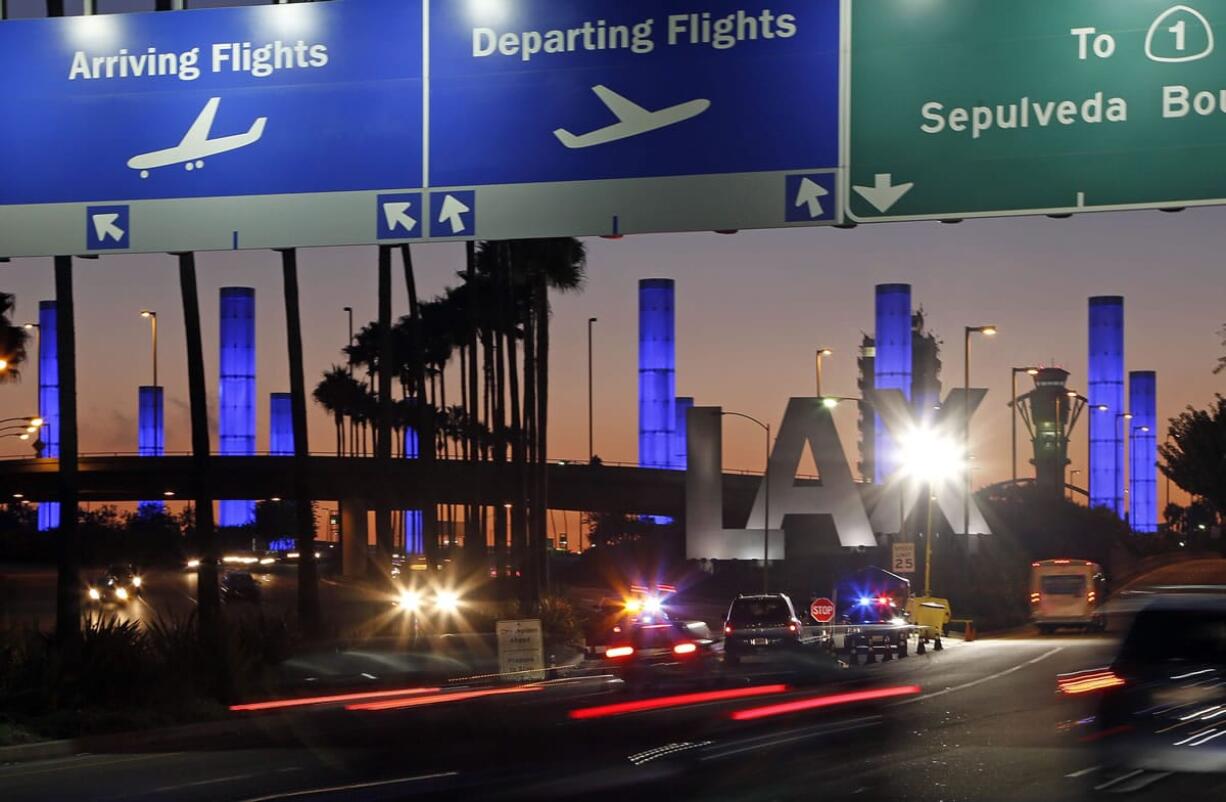 Lighted pylons at the Century Boulevard entrance to Los Angeles International Airport, which normally flash in a multicolored sequence, shine a steady blue Saturday evening in honor of Gerardo Hernandez, the Transportation Security Administration officer slain at an LAX terminal Friday. He is the first TSA officer to die in the line of duty in the history of the 12-year-old agency, created in the aftermath of the Sept. 11, 2001 terrorist attacks.