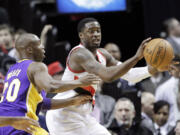 Portland Trail Blazers guard Wesley Matthews, right, passes the ball as Los Angeles Lakers guard Jodie Meeks defends during the first half of Monday's game at the Moda Center.