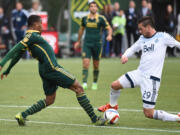 Portland Timbers defender Alvas Powell (2) goes after a ball with Vancouver Whitecaps forward Octavio Rivero (29) during the first half of an MLS western conference semifinal soccer match in Portland, Ore., Sunday, Nov. 1, 2015.