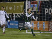 Portland Timbers' Will Johnson, right, celebrates after he scored a goal on Seattle Sounders goalkeeper Michael Gspurning, left, on a penalty kick in the first half of the second game of the Western Conference semifinals in the MLS Cup soccer playoffs, Thursday, Nov. 7, 2013, in Portland, Ore. (AP Photo/Ted S.