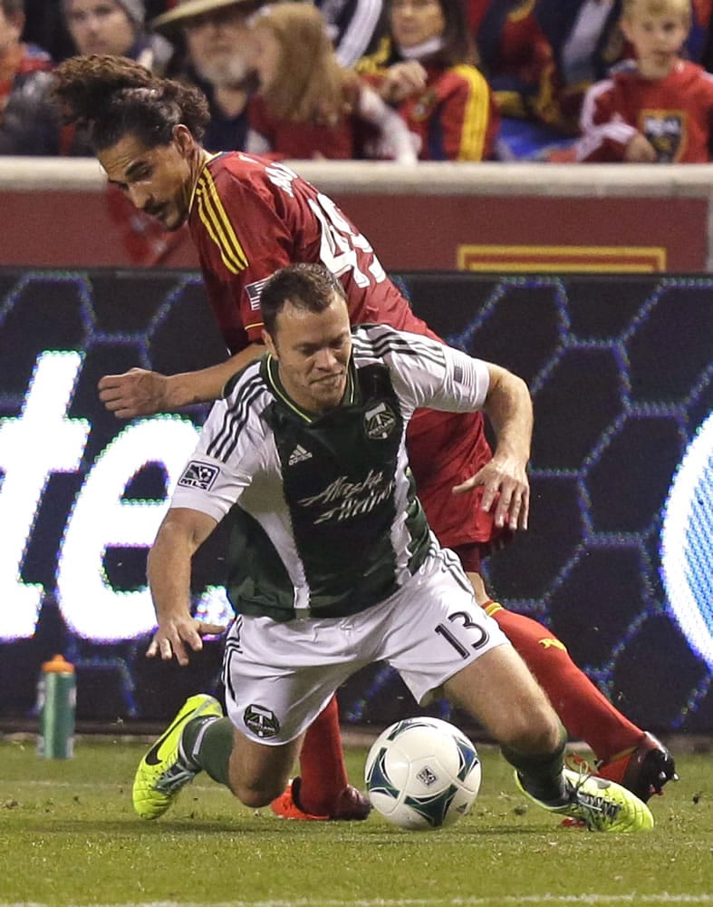 Portland Timbers' Jack Jewsbury (13) battles with Real Salt Lakes' Devon Sandoval in the first half during the first leg of the MLS Western Conference final Sunday, Nov. 10, 2013, in Sandy, Utah. Real Salt Lake won 4-2.