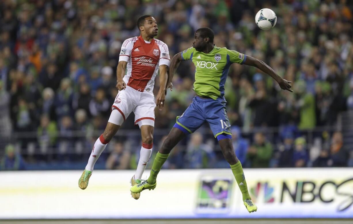 The Sounders' Djimi Traore, right, goes up against the Timbers' Ryan Johnson, left, for a header during Portland's win over Seattle on Saturday.