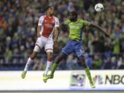 The Sounders' Djimi Traore, right, goes up against the Timbers' Ryan Johnson, left, for a header during Portland's win over Seattle on Saturday.