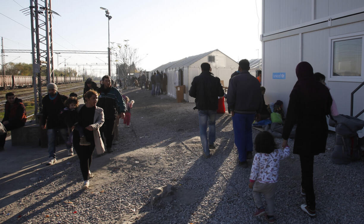 Migrants and refugees walk through the transit center for refugees near the village of Tabanovce, in northern Macedonia on the border with Serbia, on Thursday. Four nations along Europe&#039;s Balkan refugee corridor shut their borders Thursday to those not coming from war-torn countries such as Syria, Afghanistan or Iraq, leaving thousands of others seeking a better life in Europe stranded at border crossings.