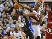 The Portland Trail Blazers' Thomas Robinson (41) defends a shot by the Orlando Magic's Arron Afflalo (4) during the second half of Wednesday's game. The Trail Blazers beat the Magic 110-94.