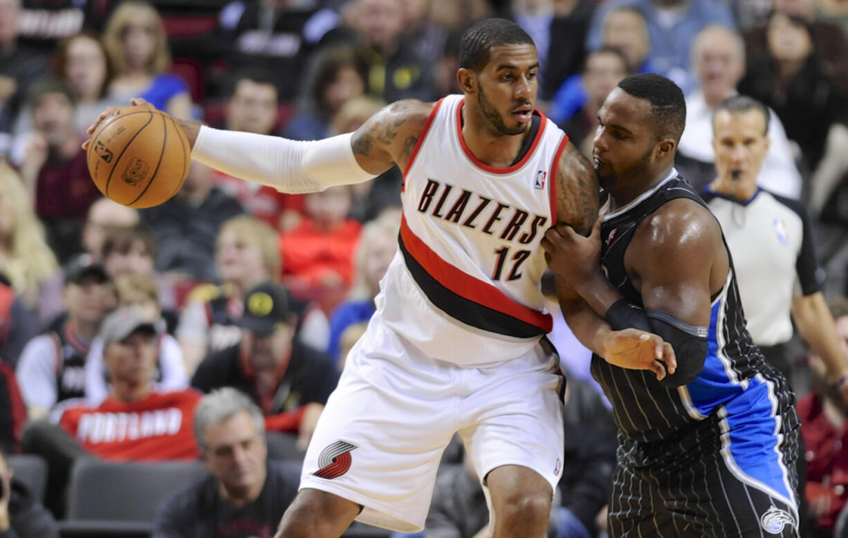 Orlando Magic's Glen Davis (11) defends Portland Trail Blazers' LaMarcus Aldridge (12) during the first half Wednesday in Portland.