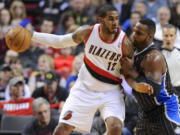 Orlando Magic's Glen Davis (11) defends Portland Trail Blazers' LaMarcus Aldridge (12) during the first half Wednesday in Portland.