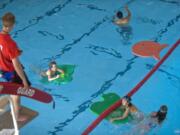 Children swim in to the pool at the Marshall Center.