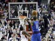 Dallas Mavericks guard Monta Ellis, right, puts up the winning shot at the buzzer Saturday as Portland Trail Blazers guard Wesley Matthews defends. Ellis scored 22 points as they beat the Trail Blazers 108-106.