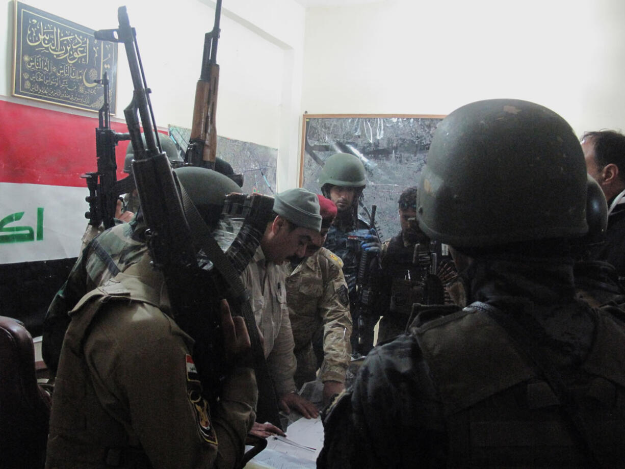 Iraqi security forces discuss the combat plan in Ramadi, 70 miles (115 kilometers) west of Baghdad, Iraq, on Monday.