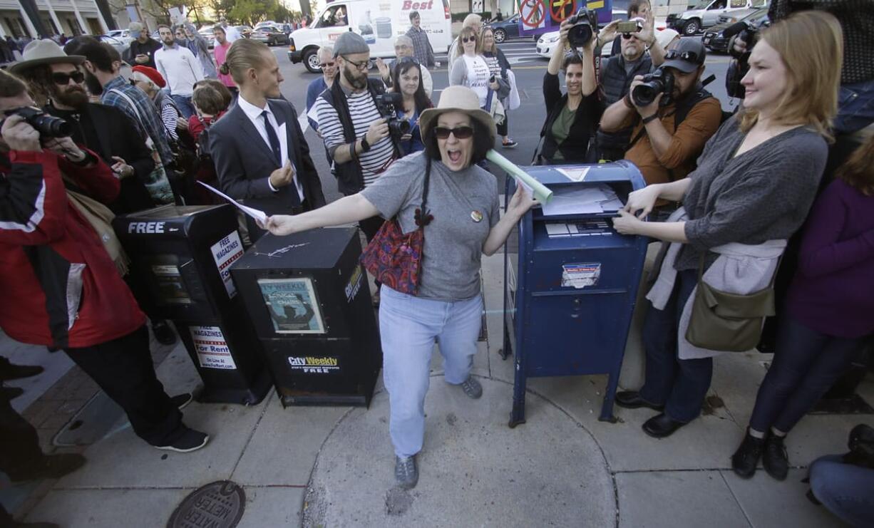 A woman celebrates before mailing her resignation letter as Mormons gathered Saturday  in Salt Lake City for a mass resignation from the Church.