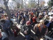 People gather during a rally for a mass resignation from the Church of Jesus Christ of Latter-day Saints Saturday, Nov. 14, 2015, in Salt Lake City. A day after the Mormon church stood behind its new rules targeting gay members and their children, while issuing clarifications, hundreds held rally in Salt Lake City to protest their displeasure with the policy changes with many renouncing their membership with The Church of Jesus Christ of Latter-day Saints.