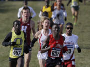 Oregon's Edward Cheserek (457), Texas Tech's Kennedy Kithuka (632), Arkansas' Kemoy Campbell (33) run during the men's NCAA Division I Cross-Country Championships Saturday, Nov. 23, 2013, in Terre Haute, Ind.