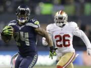 Seattle Seahawks' Marshawn Lynch (24) breaks away from San Francisco 49ers' Tramaine Brock (26) for a 40-yard touchdown run during the third quarter Sunday.